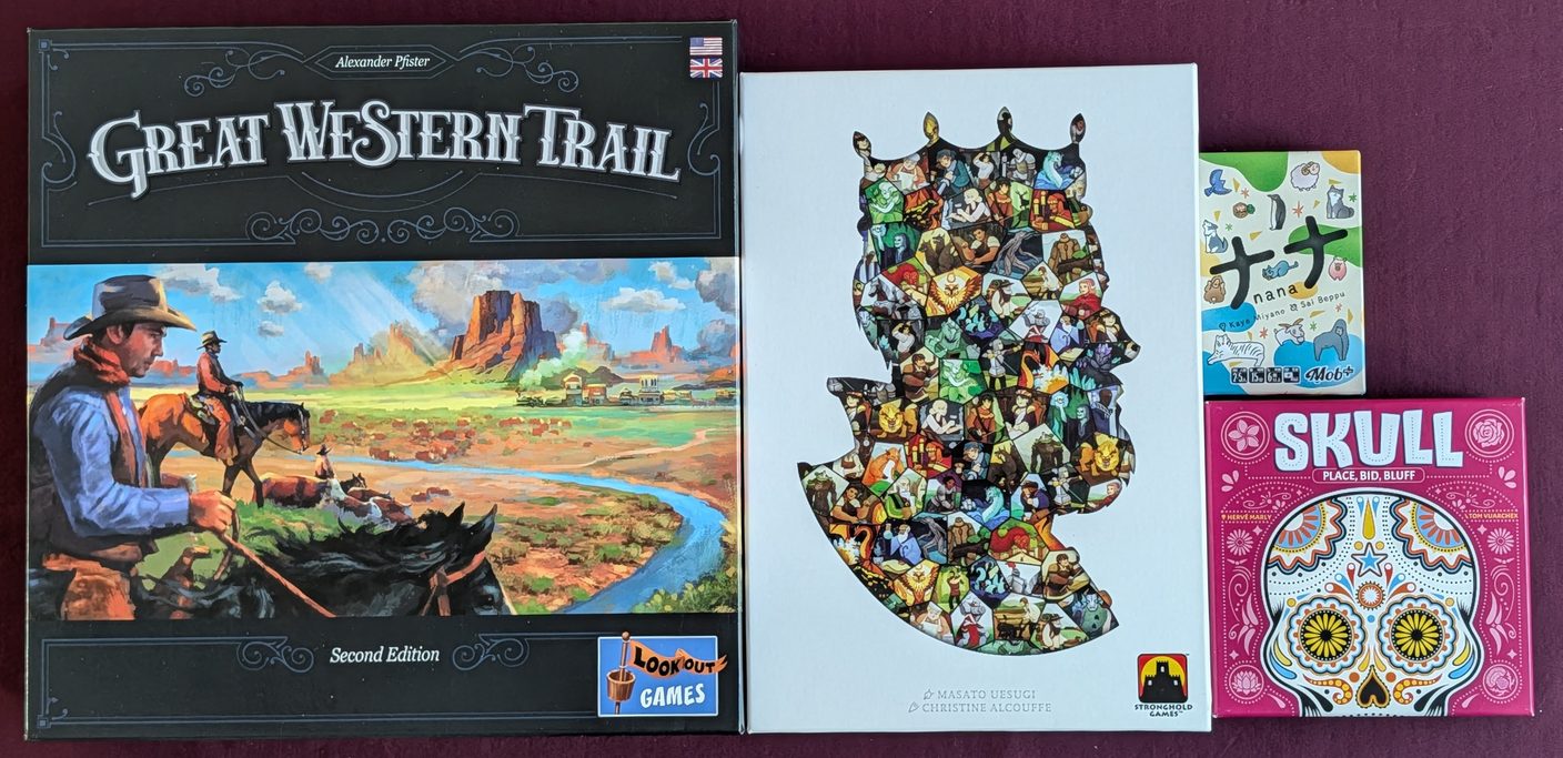 Game boxes on the table on September 26: Great Western Trail Second Edition, Paper Tales, Nana, and Skull